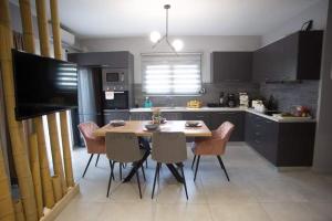 a kitchen with a table and chairs in a kitchen at RENT A HOME DANA in Porto Rafti