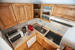 an overhead view of a kitchen with wooden cabinets at Green Garden Apartments Soklič in Bohinj