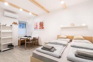 a room with four beds and a table in it at Apartments Nautilus, nearby beach Svetilnik in Izola +64 photos