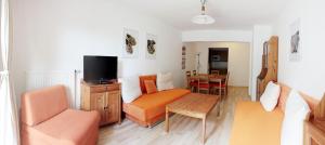 a living room with a couch and a table at Apartmány Lipno Bouček in Lipno nad Vltavou