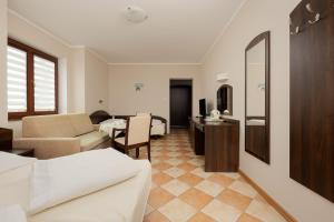 a living room with a couch and a table at Holiday House Europa in Rewal
