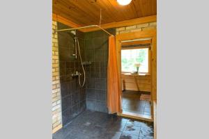 a bathroom with a shower and a sink at Pirtsmāja Villa Marta in Cēsis