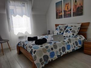 a bedroom with a bed with a laptop on it at Appart'HomeCity - Rouen Lessard in Rouen