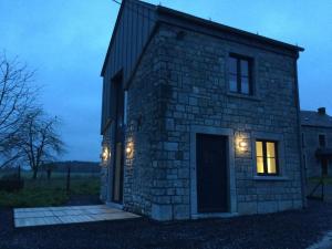 a stone house with lights on the side of it at Honey House in Foy-Notre-Dame