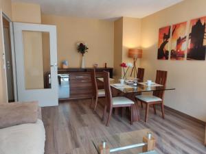 a living room with a table and a dining room at Appart'HomeCity - Rouen Lessard in Rouen