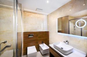 a bathroom with a sink and a mirror at Hotel Akvamarín in Bešeňová