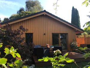 a house with a deck and a patio at Ferienhaus Eldena Greifswald Steffi Fasten in Eldena