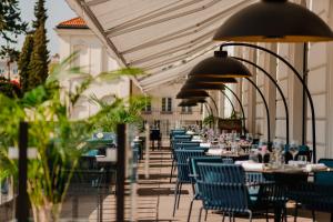 a long row of tables and chairs in a building at Raffles Europejski Warsaw in Warsaw