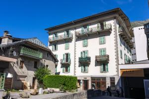 a large white building with balconies on a street at Le Beaulieu - Happy Rentals in Chamonix-Mont-Blanc