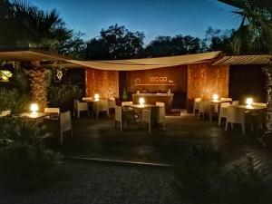 a restaurant with tables and lights in the night at Vallegrande Nature Resort by Geocharme in Cefalù