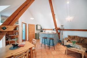 a kitchen and living room with a table and chairs at Winzerhof & Weincafe Gümpelein in Willanzheim