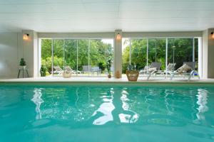 a swimming pool with blue water in a house at VILLA VARENTIA in Villers-Bretonneux