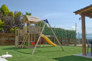 a playground with a slide and a swing set at Epipleon Luxury Suites -101- Δωμάτιο 45τμ με βεράντα 30τμ μπροστά στη θάλασσα in Nafpaktos