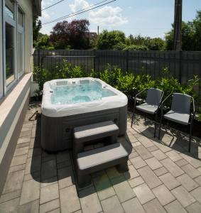 a hot tub sitting on top of a patio at Deluxe Apartman Visegrád in Visegrád