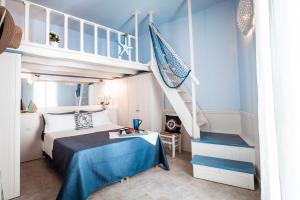 a bedroom with a bunk bed and a staircase at Chiasso S. Anna Relax Apartments near the sea in Monopoli