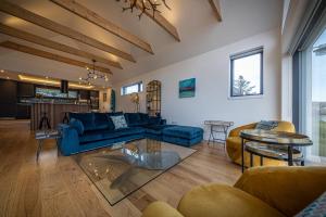 a living room with a blue couch and chairs at Tides Uig Isle of Skye in Uig