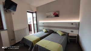 Postel nebo postele na pokoji v ubytování Hotel Del Negro