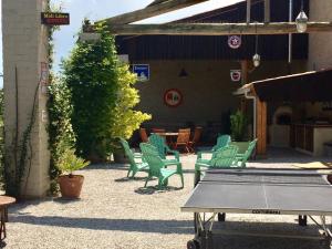 eine Gruppe grüner Stühle und ein Tisch auf einer Terrasse in der Unterkunft Domaine Saladry in Villepinte