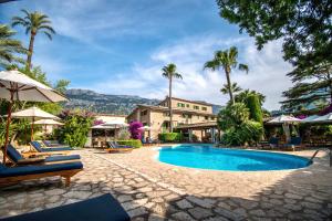 a resort with a swimming pool and palm trees at Son Grec Petit Resort - Adults Only in Sóller