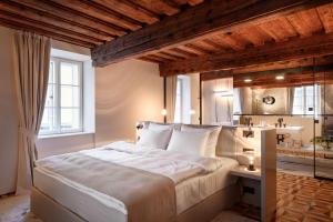 a bedroom with a large bed and a sink at Zlata Ladjica Boutique Hotel in Ljubljana