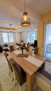 a dining room and living room with a table and chairs at Apartment AXA in Ohrid