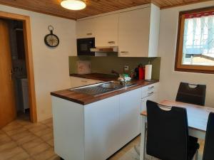 a kitchen with a sink and a counter top at Chalet Clair de Lune bei Grächen VS in Gasenried