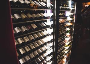 a refrigerator filled with lots of bottles of wine at La Ferme in La Clusaz