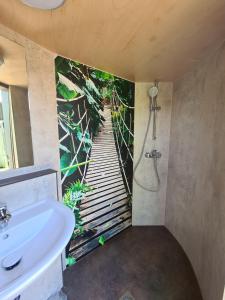 a bathroom with a shower and a sink at Schlaffässer am Schmetterlingspark in Uslar