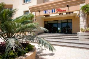 The facade or entrance of Swiss Inn Plaza Hotel