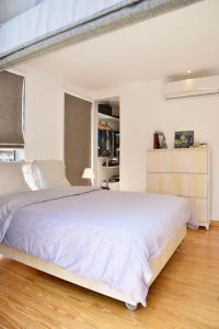 a white bedroom with a large bed in it at VESTA - Heliopolis Residence in Cairo