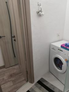 a laundry room with a washing machine and a door at Аренда квартиры in Izmail