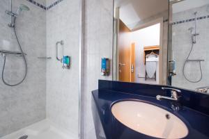 a bathroom with a sink and a shower at Holiday Inn Express Stirling, an IHG Hotel in Stirling