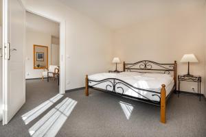 a bedroom with a bed and a hallway at Apartma La Provence in Mariánské Lázně