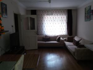 a living room with a couch and a window at Camlik Apart Hotel in Macka