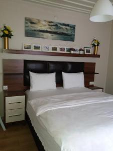 sypialnia z dużym łóżkiem z drewnianym zagłówkiem w obiekcie Camlik Apart Hotel w mieście Macka