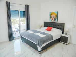 a bedroom with a bed and a large window at Apartments Gjenashaj in Ulcinj +136 photos