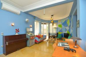 a living room with blue walls and a piano at Athens Designer's home 3 min to Monastiraki metro in Athens