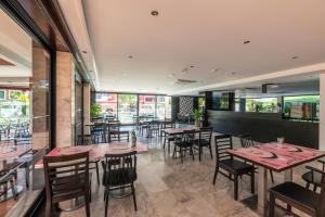 a dining room with tables and chairs in a restaurant at Topazio Vibe Beach Hotel & Apartments - Adults Friendly in Albufeira