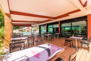 an outdoor patio with tables and chairs and windows at Topazio Vibe Beach Hotel & Apartments - Adults Friendly in Albufeira