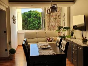 a living room with a table and a couch at Parque das Amendoeiras in Vilamoura