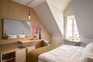 a bedroom with a large mirror and a bed at Zlata Ladjica Boutique Hotel in Ljubljana