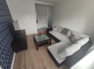 a living room with a couch and a coffee table at 300 metrów od plaży / 300 meters from the beach in Gdańsk