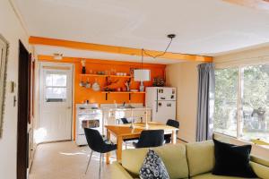 a living room with a couch and a table at Colonial Bay Motel and Cottages in Huntsville