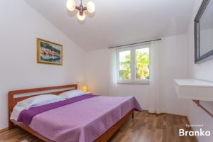 Postel nebo postele na pokoji v ubytování Apartmani Bego