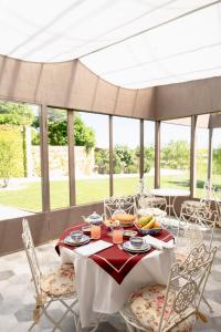 a white table with chairs and food on it at Pampucet in Colcavagno