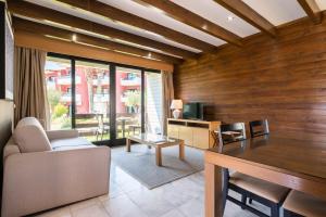 a living room with a couch and a table at Topazio Vibe Beach Hotel & Apartments - Adults Friendly in Albufeira