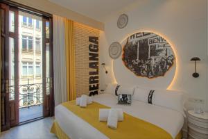 a hotel room with a bed and a large window at Casual Socarrat Valencia - Adults Only in Valencia