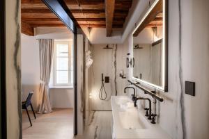 a bathroom with a sink and a mirror at Zlata Ladjica Boutique Hotel in Ljubljana