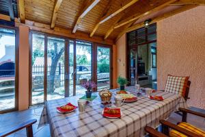 a table with food on it in a room with windows at Apartments Kiki 150 METERS TO THE BEACH in Banjole