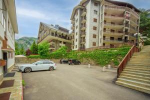 a car parked in a parking lot next to a building at Appartamento Camille in Courmayeur